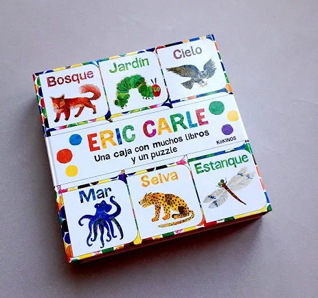 UNA CAJA CON MUCHOS LIBROS Y PUZZLE DE E CARLE